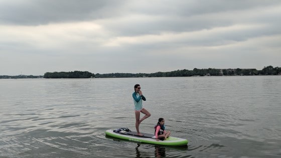 Oconomowoc City Beach Watercraft rentals May weekend guide mom and child on paddleboard on lake