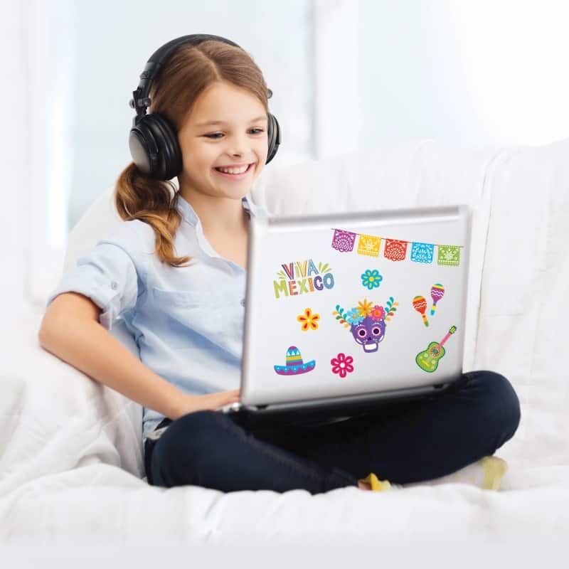 Girl sitting with computer and headphones learning futura language schools enrichment program
