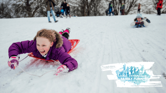 Kids Sliding on Sleds Down Snow Hill in Winter Stock Photo - Image